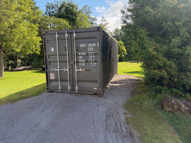 Shipping container placed on a gravel driveway